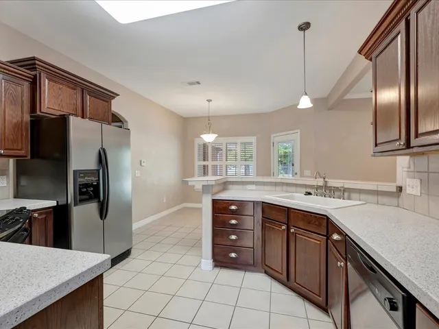 a kitchen with a sink appliances and cabinets