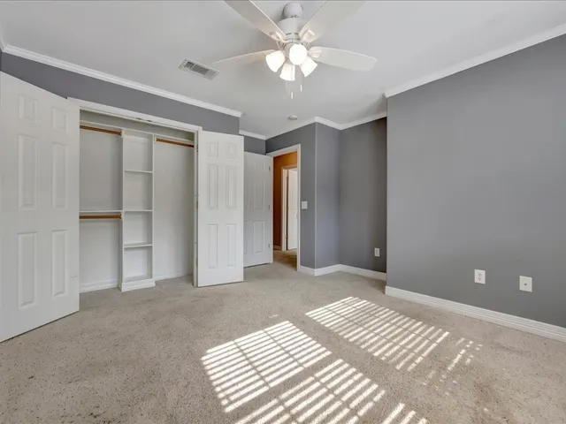 a view of a room with a ceiling fan and a ceiling fan