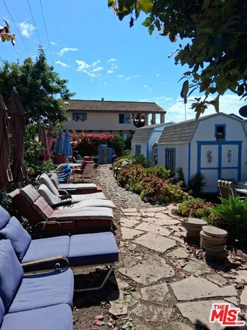 a view of an outdoor space with a patio and a garden