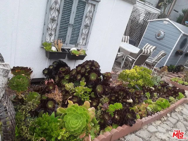 a view of a patio with a table and chairs under an umbrella