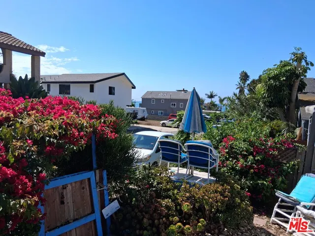 a front view of a house with swimming pool and sitting area
