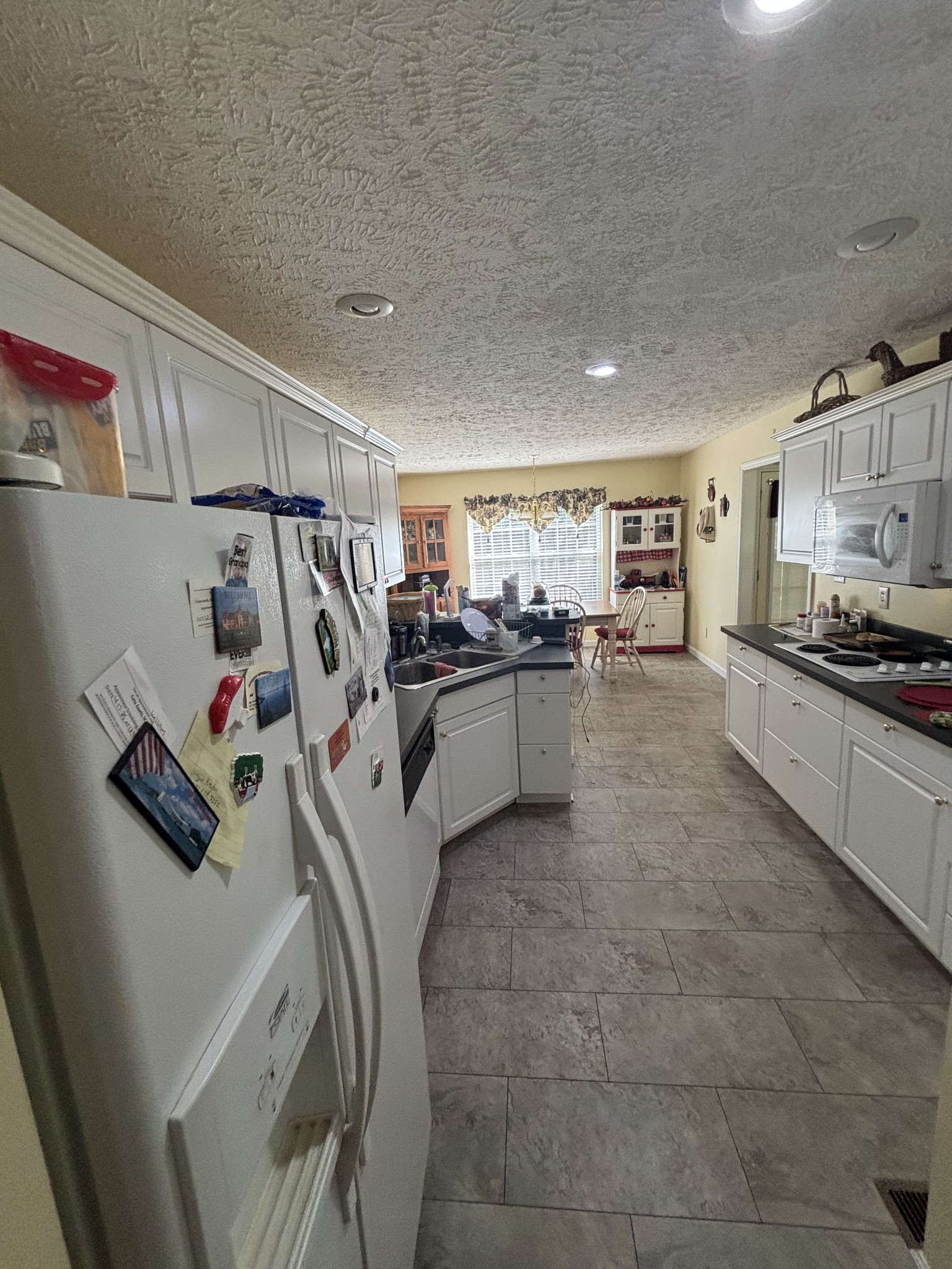 206 Dreaden Street Waverly, TN 37185 - Photo 11 of 26 a kitchen with stainless steel appliances granite countertop a sink and cabinets
