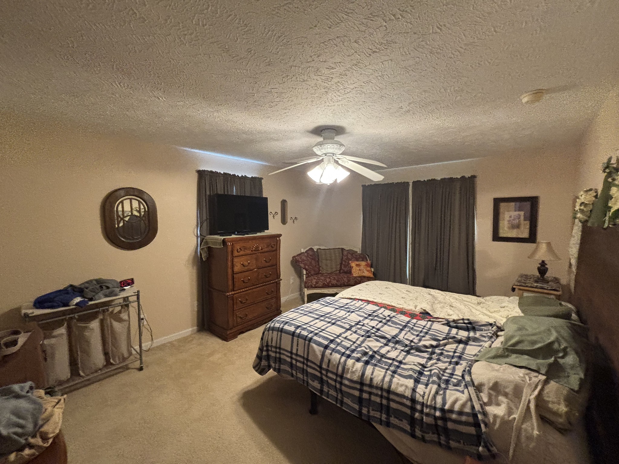 206 Dreaden Street Waverly, TN 37185 - Photo 14 of 26 a bedroom with a bed and a flat tv screen on dresser