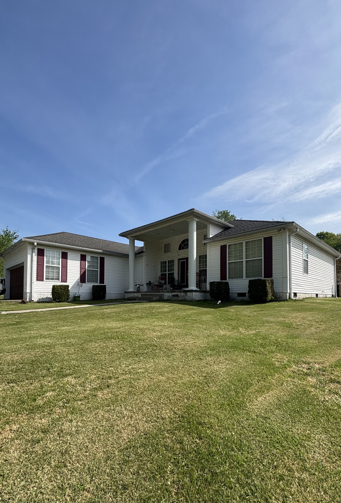 206 Dreaden Street Waverly, TN 37185 - Photo 2 of 26 a front view of a house with a garden