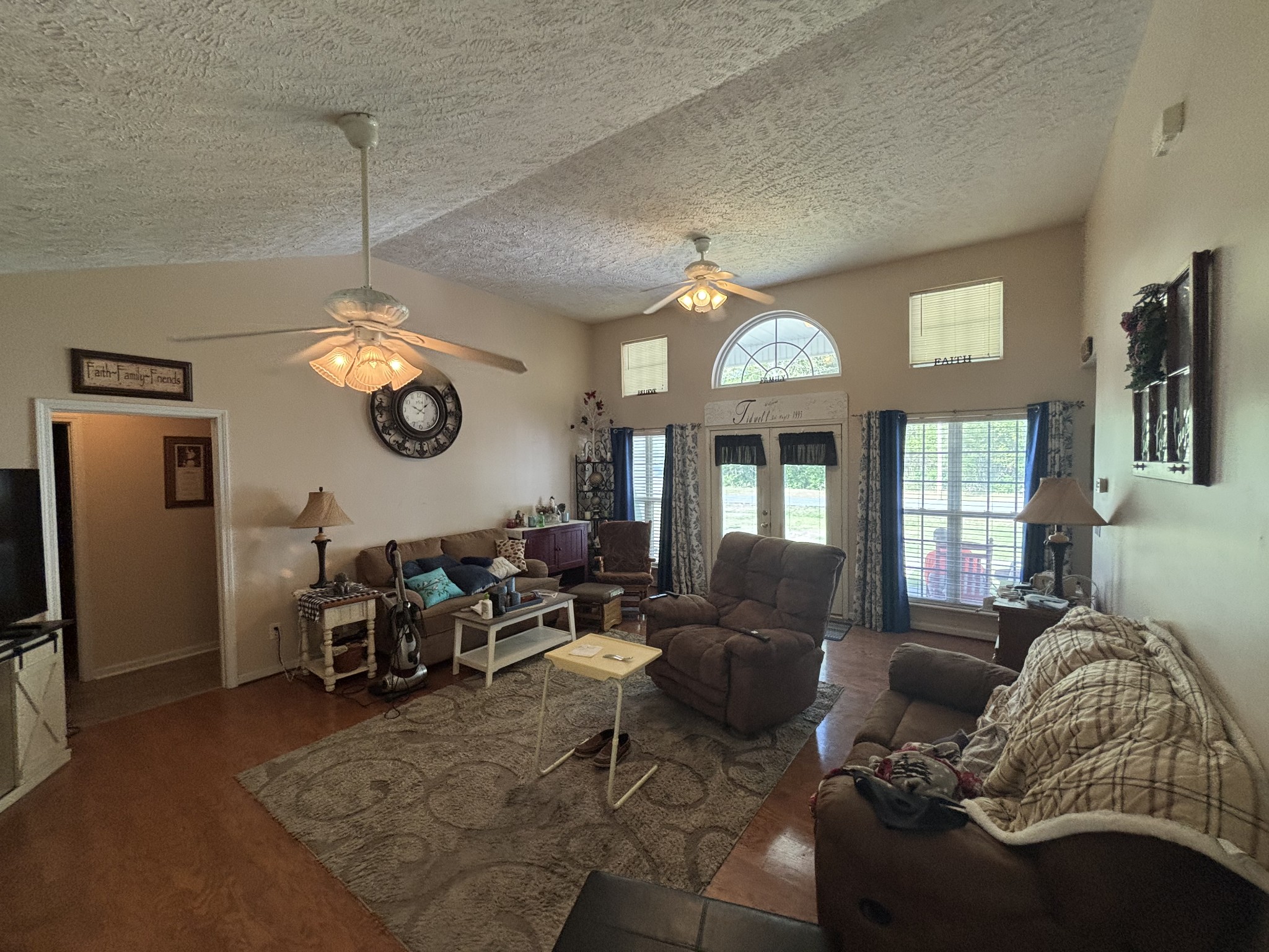 206 Dreaden Street Waverly, TN 37185 - Photo 8 of 26 a living room with furniture a chandelier and a large window