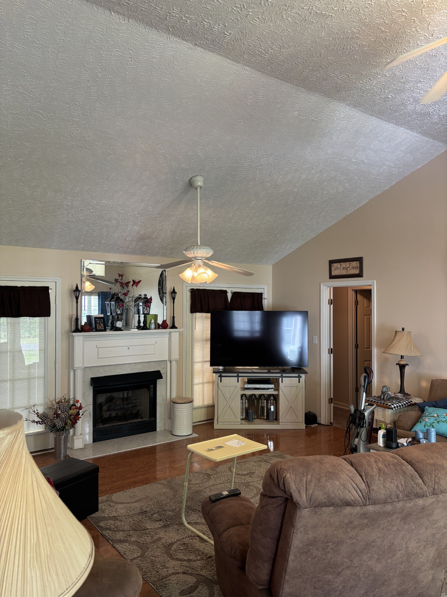 206 Dreaden Street Waverly, TN 37185 - Photo 9 of 26 a living room with furniture a fireplace and a flat screen tv
