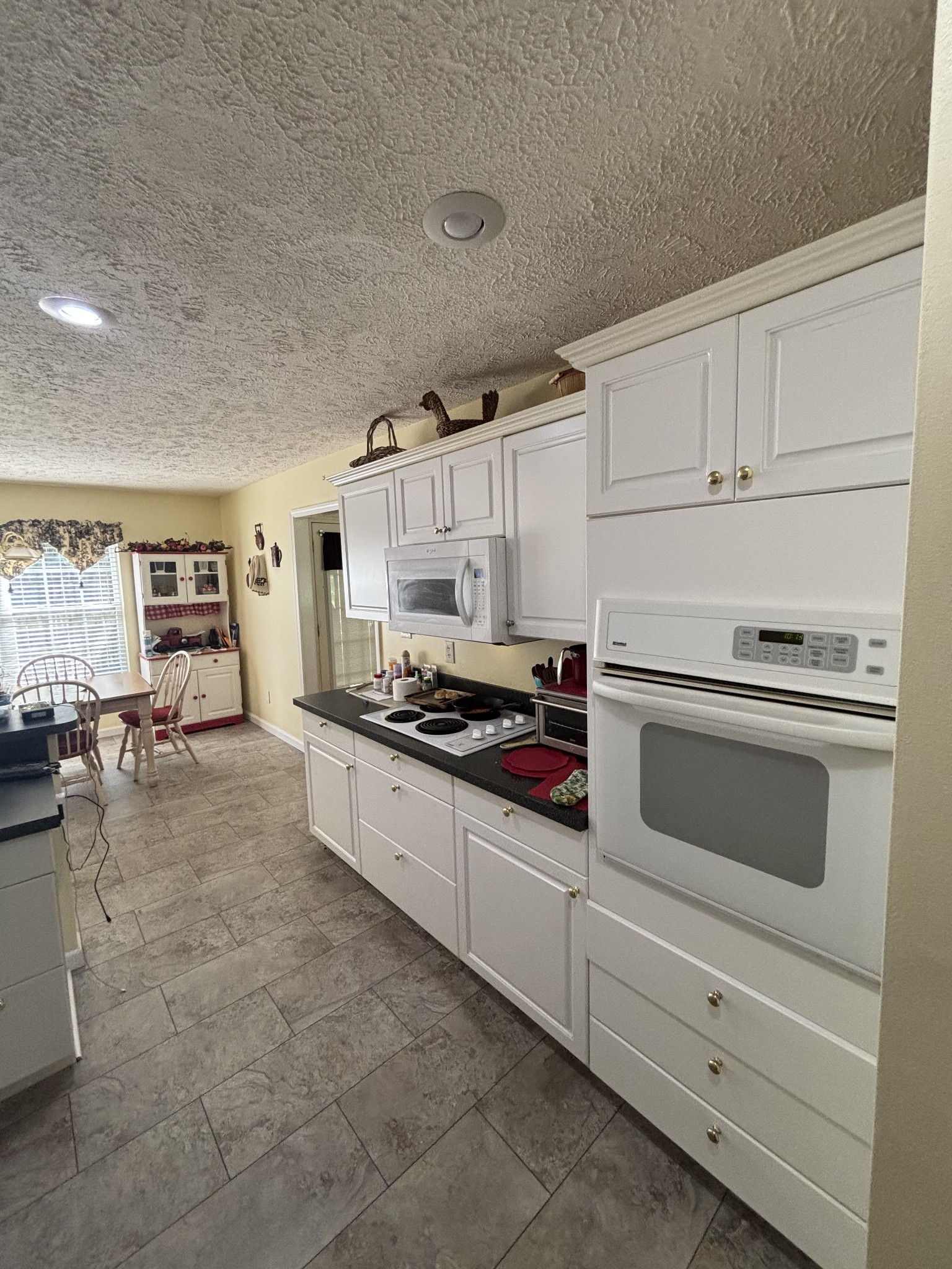 206 Dreaden Street Waverly, TN 37185 - Photo 10 of 26 a kitchen with granite countertop a stove sink and cabinets