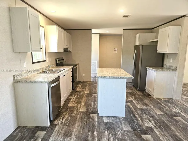 a kitchen with a sink stove and refrigerator