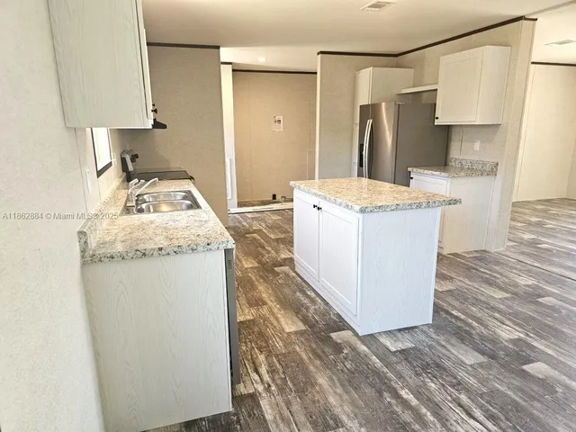 a kitchen with a stove a refrigerator and a sink