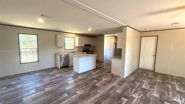 a view of a kitchen with a sink dishwasher and a refrigerator