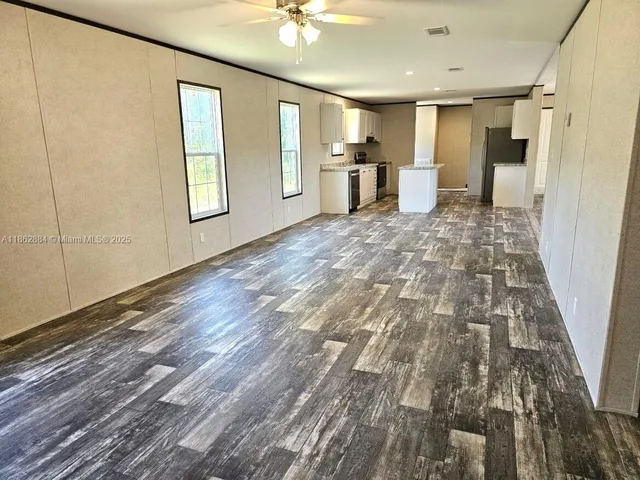 a view of a kitchen with a sink and a window