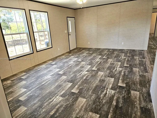 a view of an empty room with windows