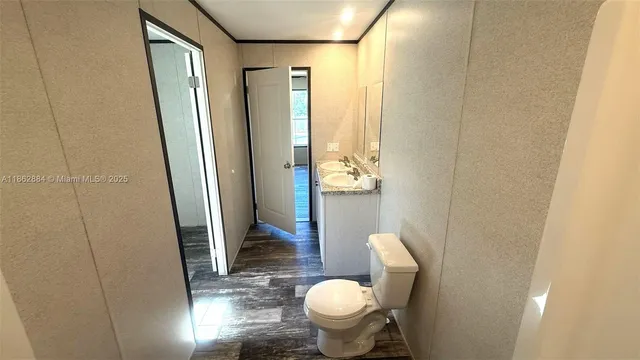 a bathroom with a toilet and a mirror