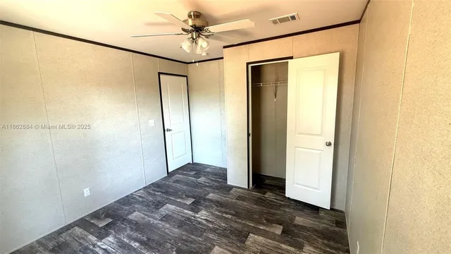 a view of room with wooden floor and fan