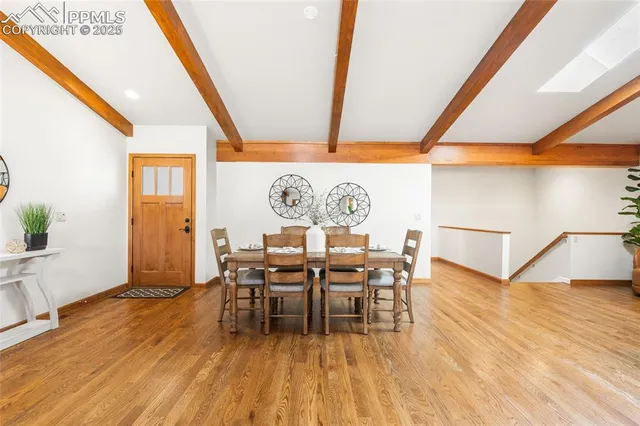 a dining room with furniture and wooden floor