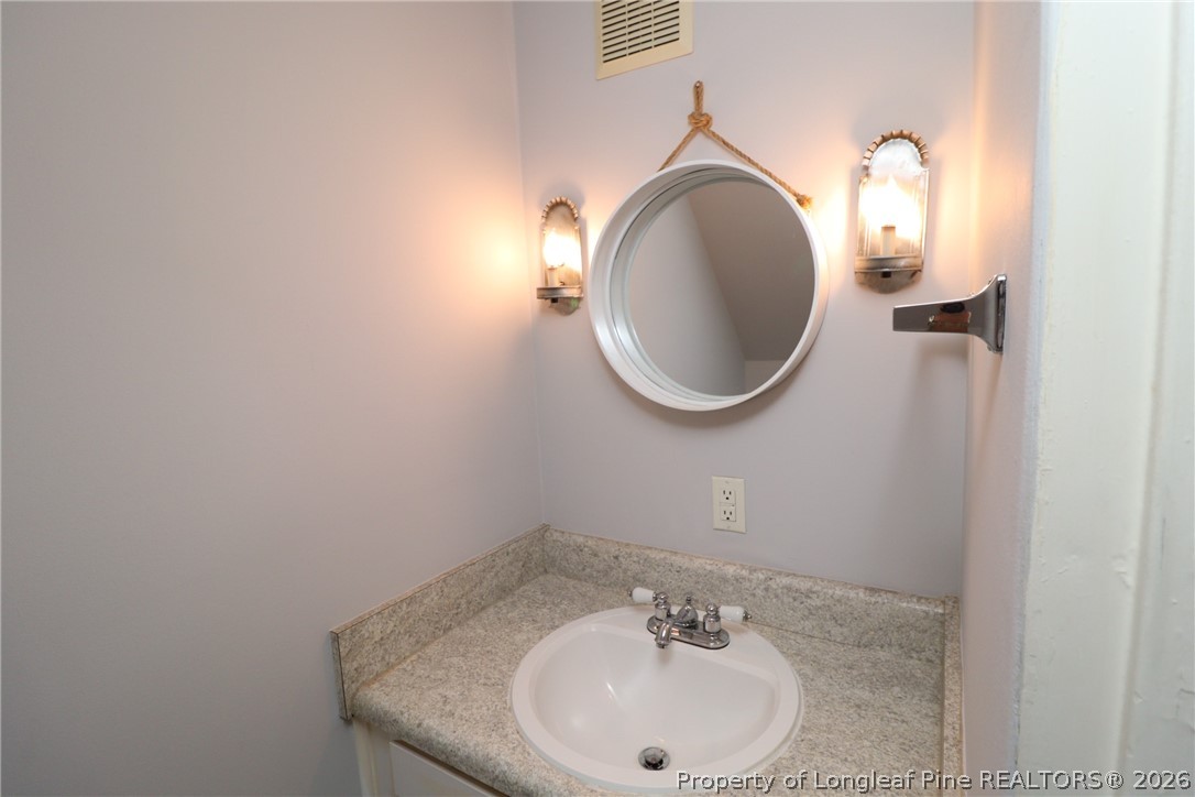 1000 Nichols Drive Raleigh, NC 27605 - Photo 12 of 22 a bathroom with a sink and a mirror