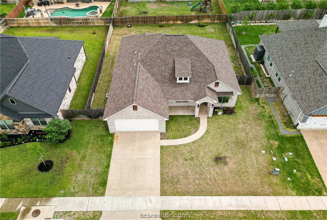 an aerial view of a house with a garden and a small yard