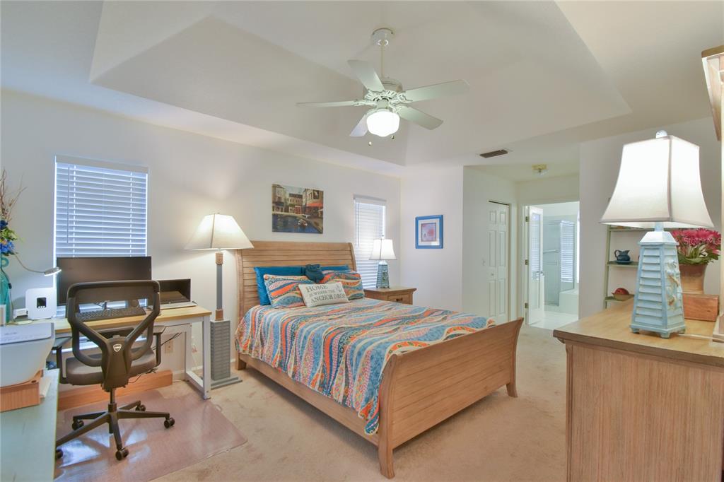 5366 Northwest 21st Loop Ocala, FL 34482 - Photo 12 of 36 a bedroom with a bed a table and chair