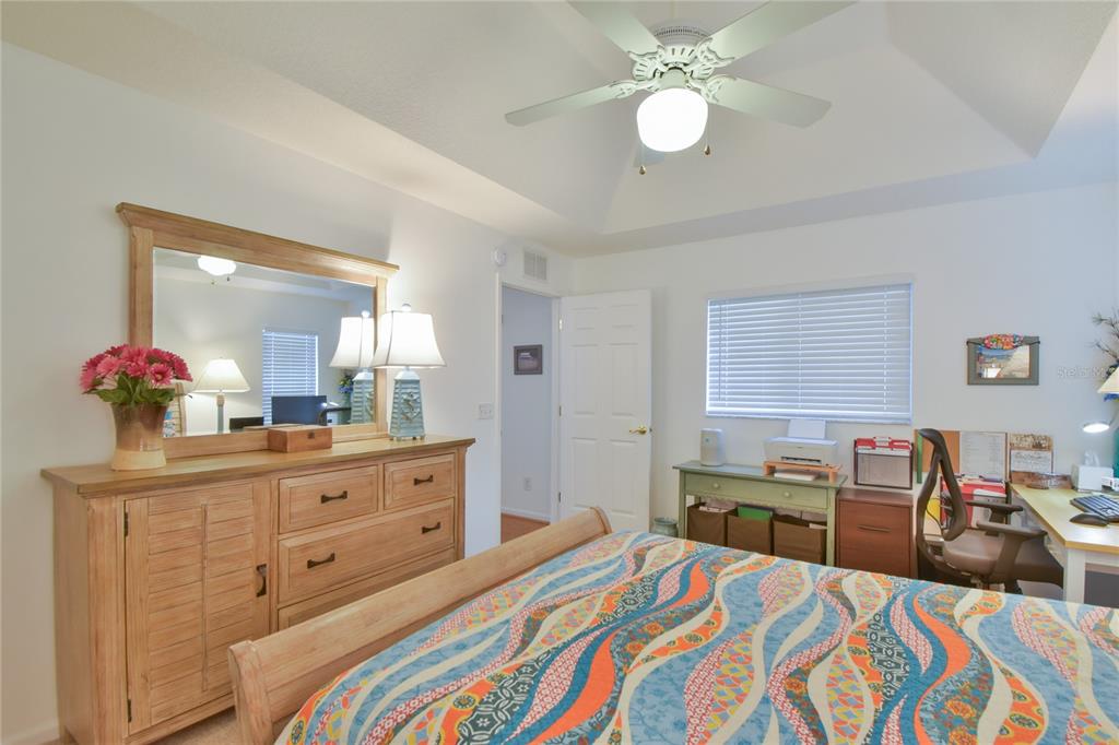 5366 Northwest 21st Loop Ocala, FL 34482 - Photo 13 of 36 a bedroom with a bed and a chandelier