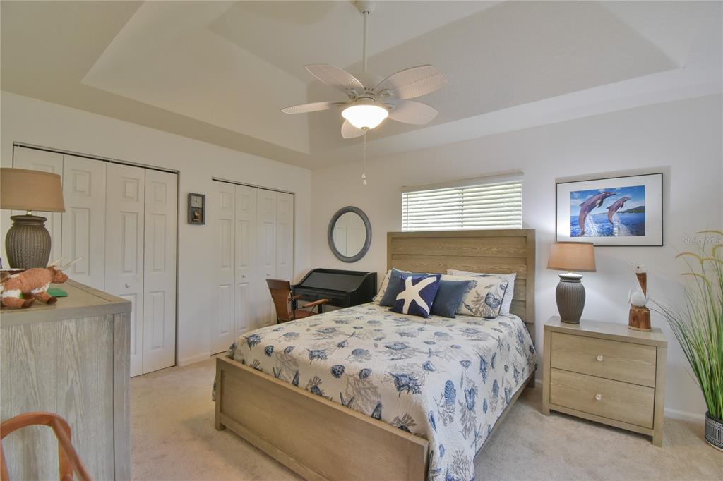 5366 Northwest 21st Loop Ocala, FL 34482 - Photo 16 of 36 a bedroom with a bed and a chandelier