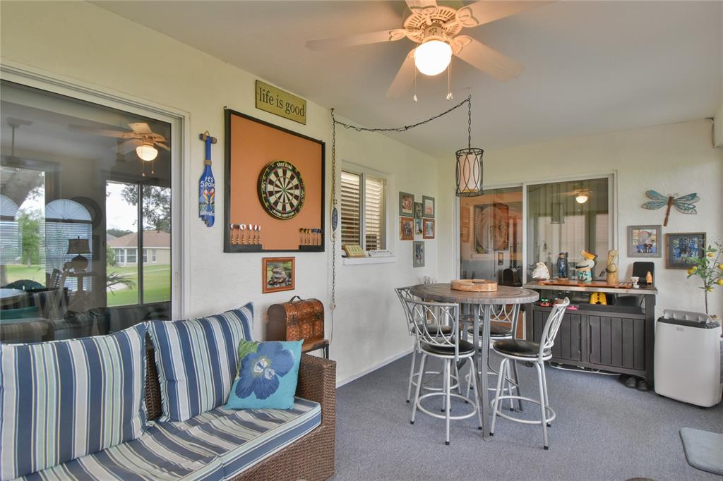 5366 Northwest 21st Loop Ocala, FL 34482 - Photo 20 of 36 a view of a dining room and livingroom with furniture wooden floor a chandelier