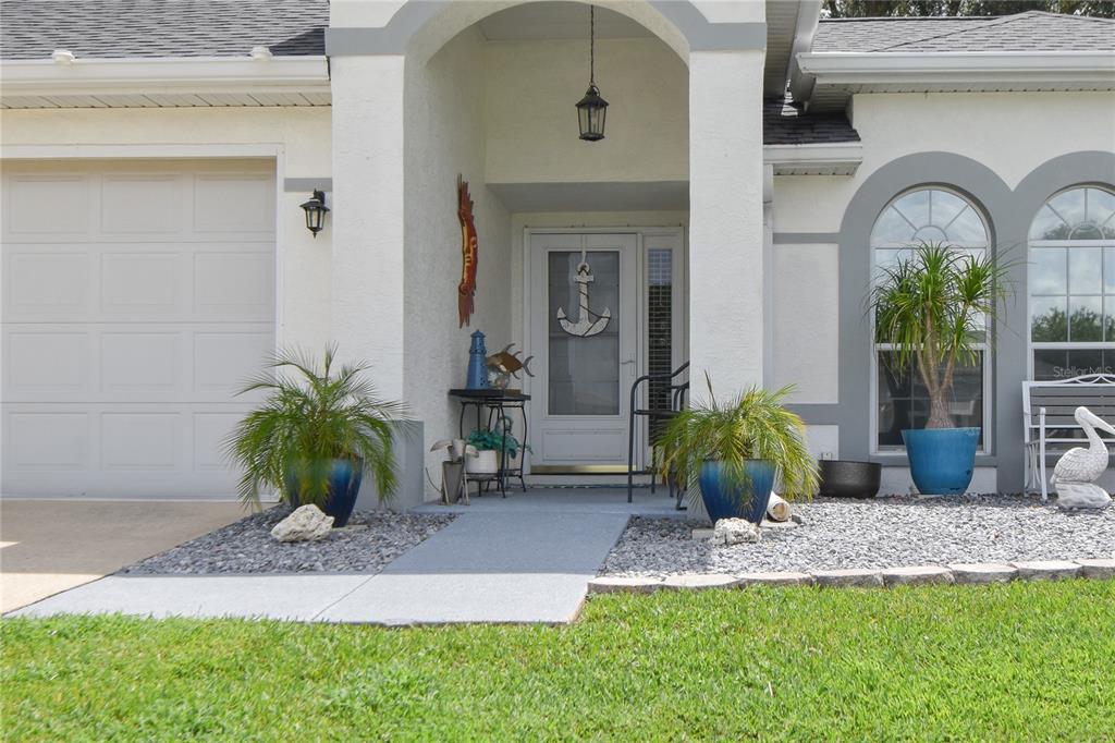5366 Northwest 21st Loop Ocala, FL 34482 - Photo 2 of 36 a front view of a house with garden