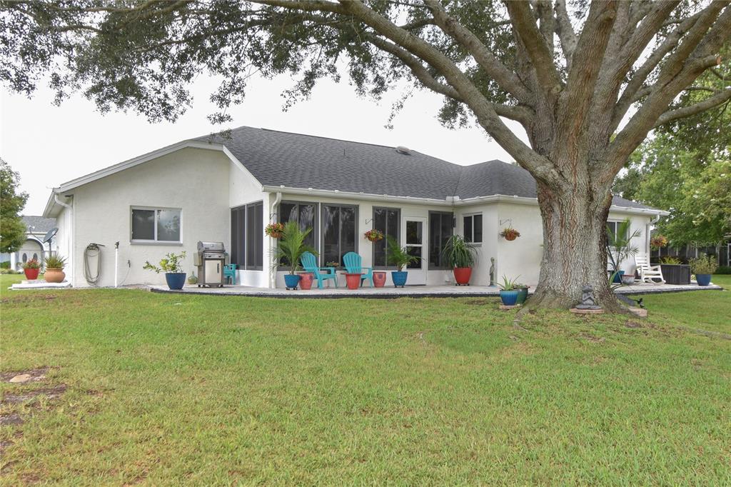5366 Northwest 21st Loop Ocala, FL 34482 - Photo 23 of 36 a view of a house with a yard patio and a tree