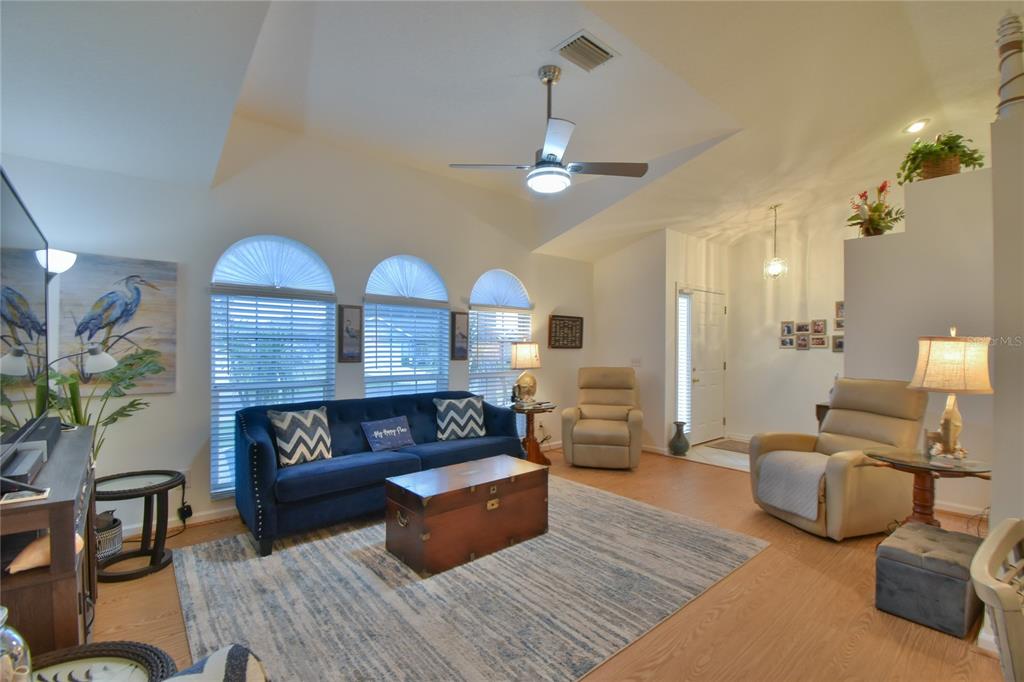 5366 Northwest 21st Loop Ocala, FL 34482 - Photo 4 of 36 a living room with furniture and a wooden floor
