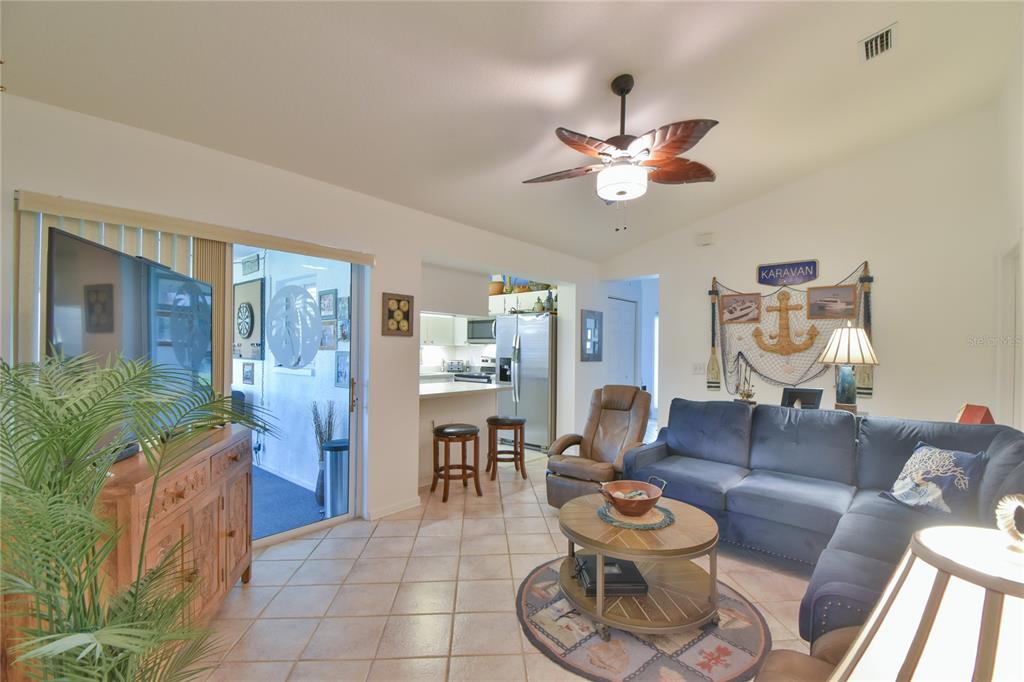 5366 Northwest 21st Loop Ocala, FL 34482 - Photo 9 of 36 a living room with furniture and a chandelier