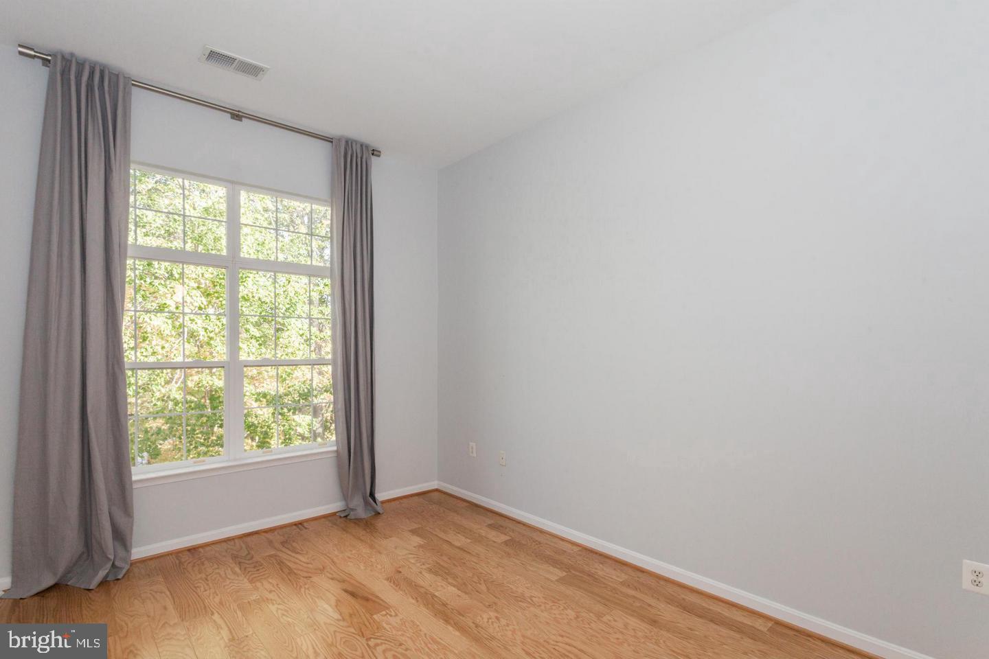 11401 Gate Hill Place, Unit 72 Reston, VA 20194 - Photo 16 of 30 Master Bedroom with Wood Floor and Vaulted Ceiling