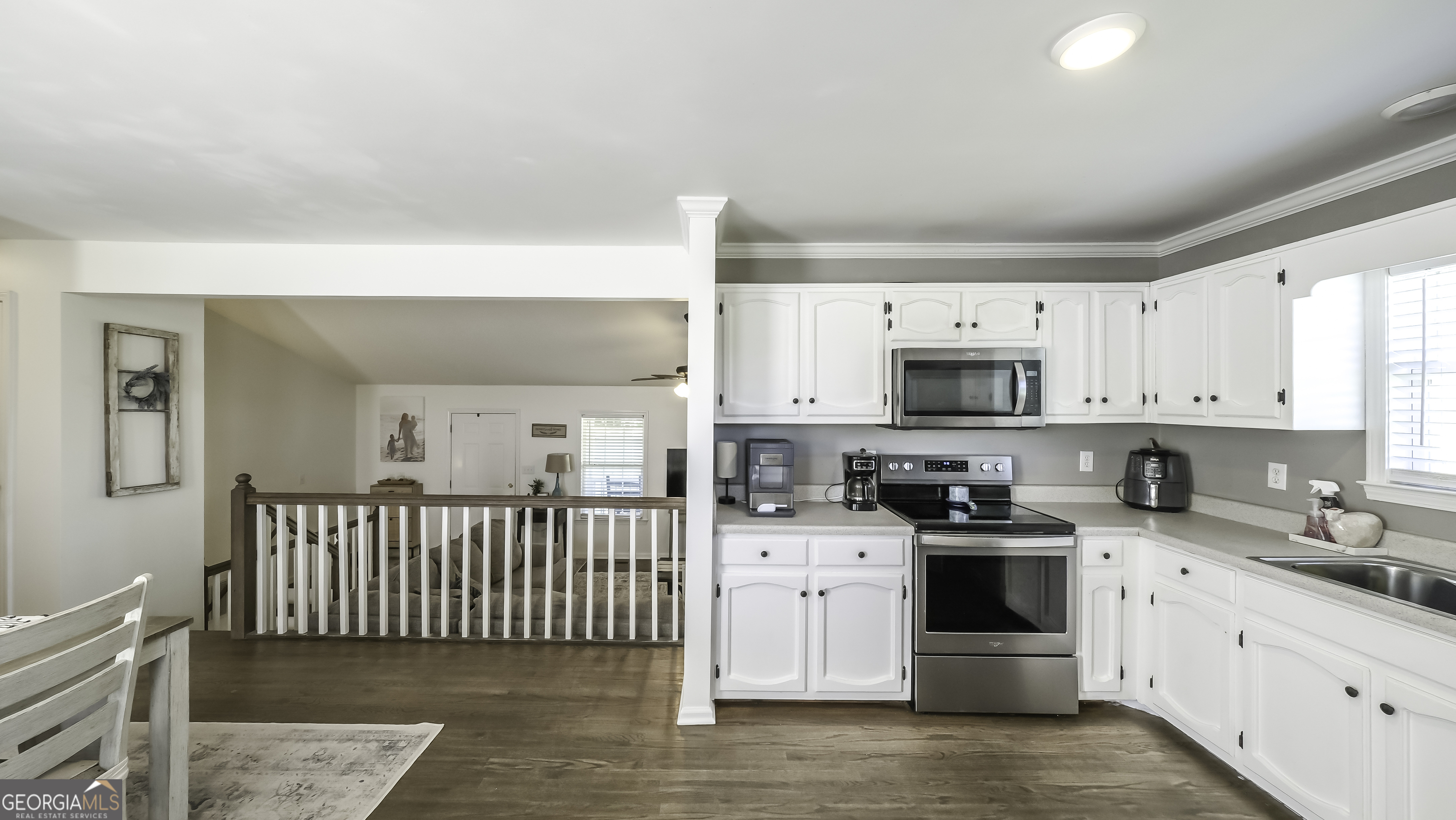 505 Miranda Way Temple, GA 30179 - Photo 12 of 33 a kitchen with stainless steel appliances a white cabinets and wooden floor