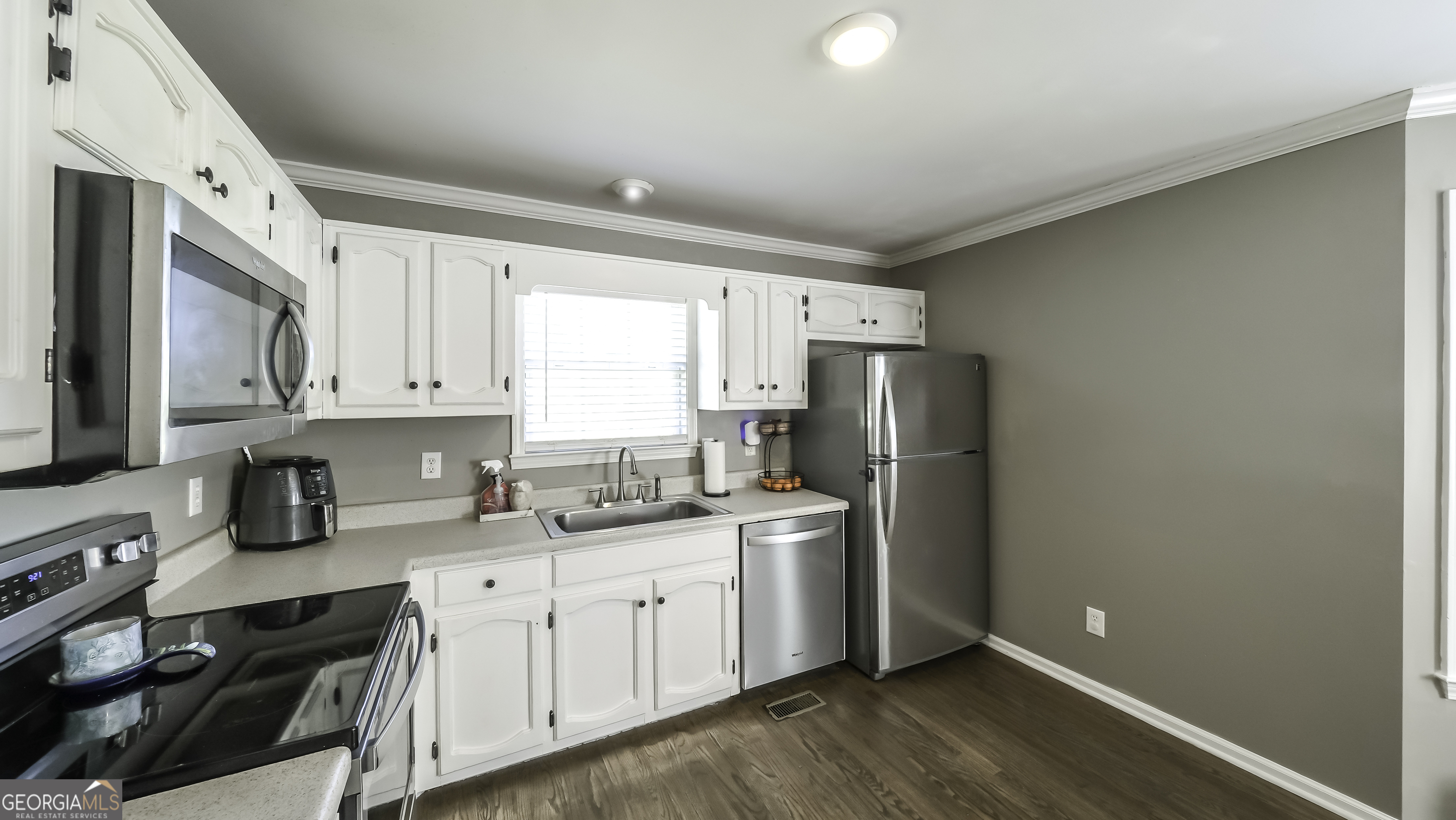 505 Miranda Way Temple, GA 30179 - Photo 13 of 33 a kitchen with a sink a refrigerator and cabinets