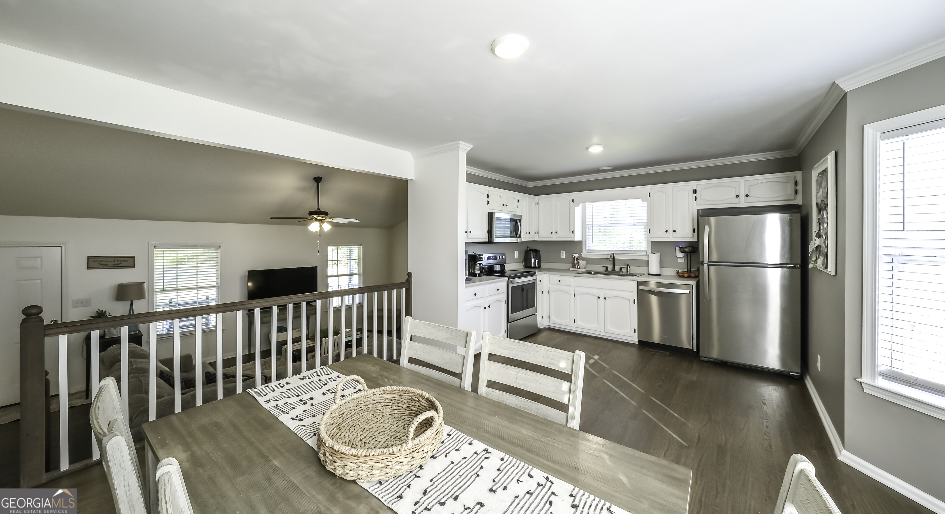 505 Miranda Way Temple, GA 30179 - Photo 17 of 33 a kitchen with white cabinets and stainless steel appliances