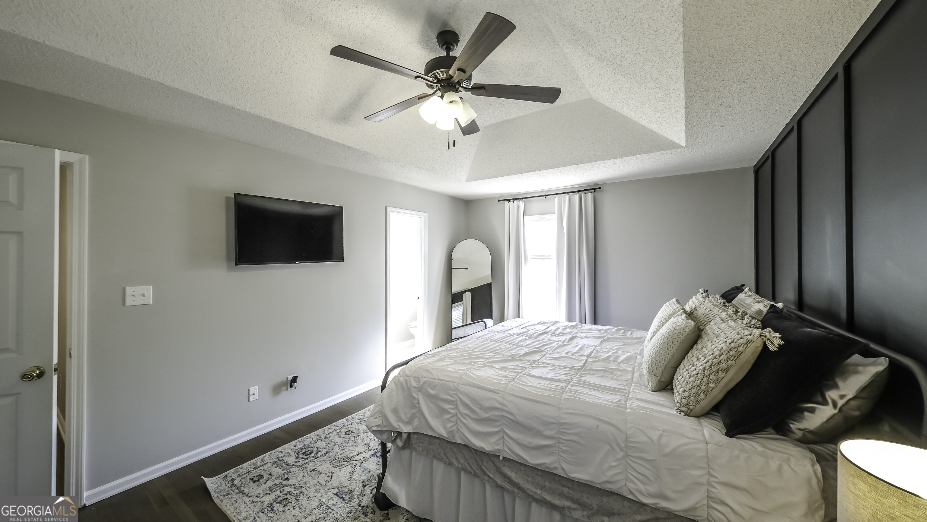 505 Miranda Way Temple, GA 30179 - Photo 19 of 33 a bedroom with a large bed and a tv