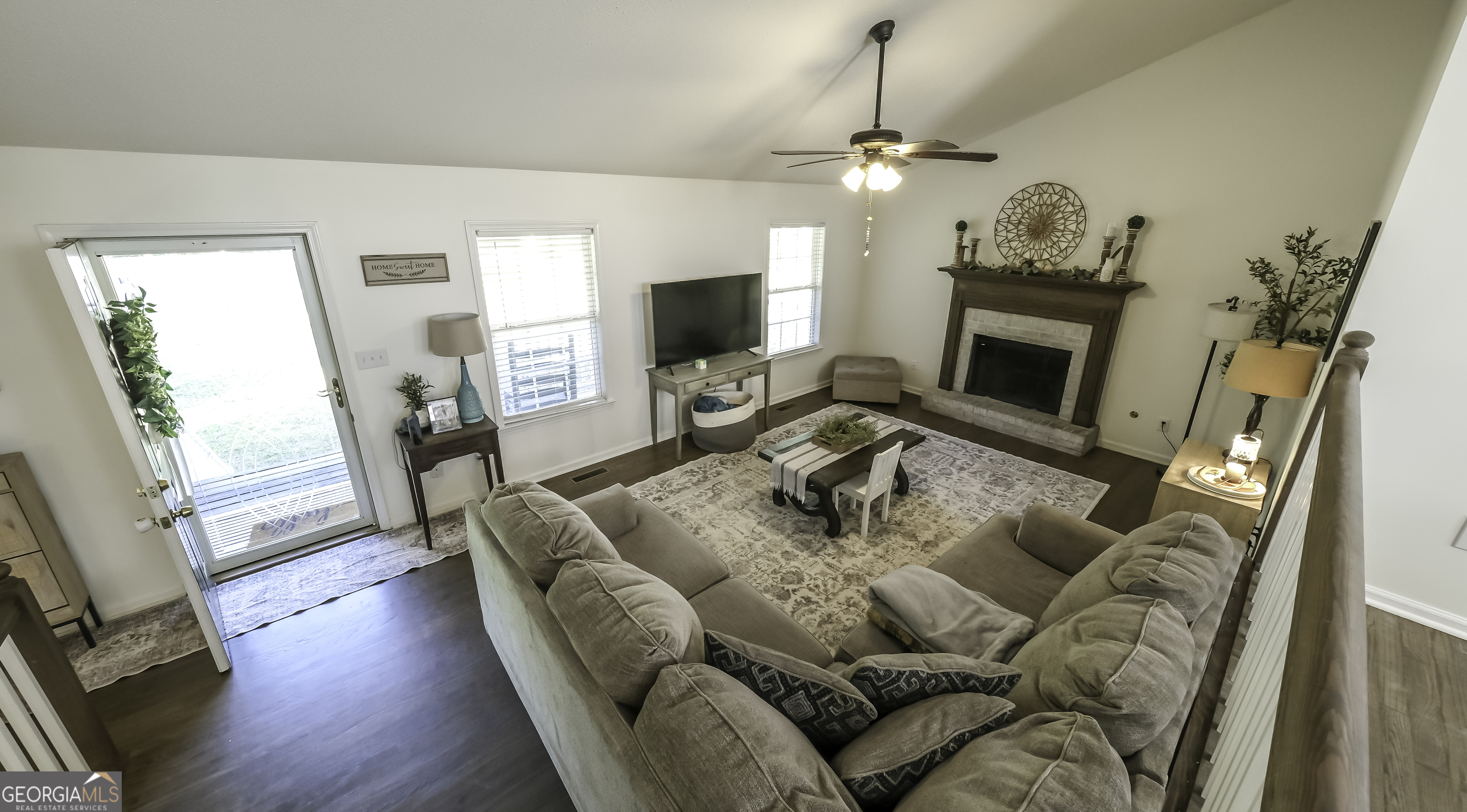 505 Miranda Way Temple, GA 30179 - Photo 9 of 33 a living room with furniture a fireplace and a flat screen tv