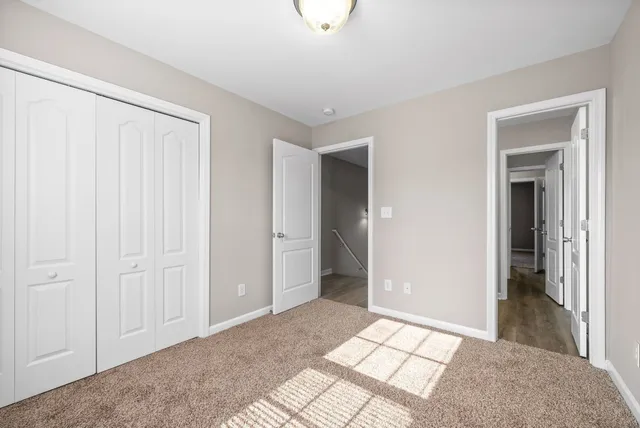 a view of a big room with closet and windows