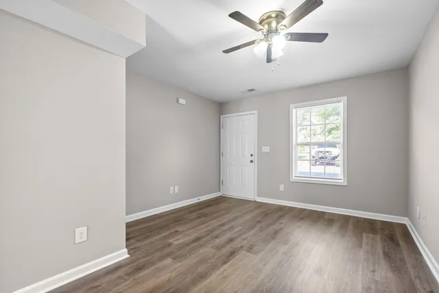 wooden floor in an empty room with a window