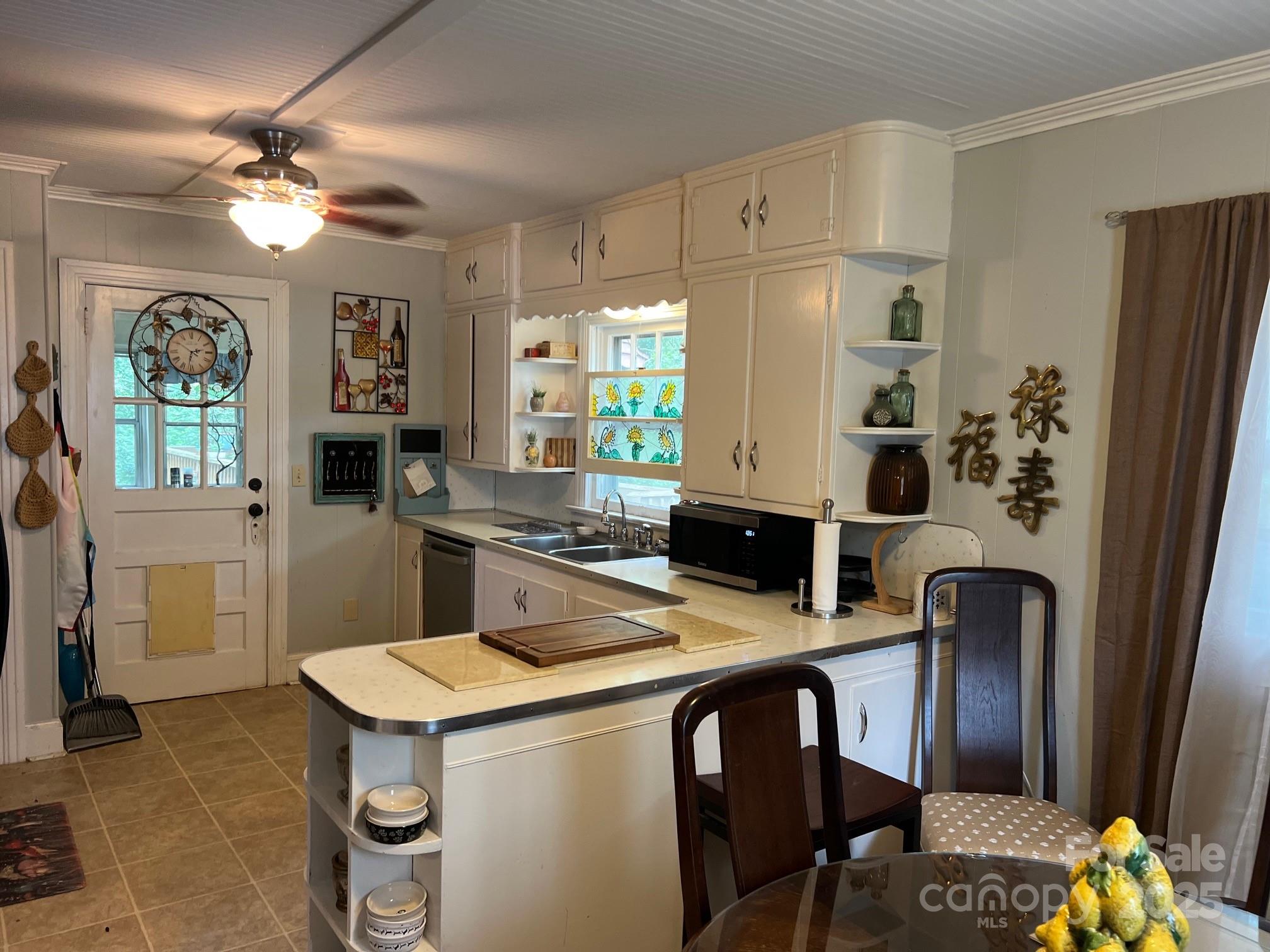 404 Patton Street Morganton, NC 28655 - Photo 20 of 40 a kitchen with stainless steel appliances kitchen island granite countertop a refrigerator a stove a microwave oven with a dining table and chairs