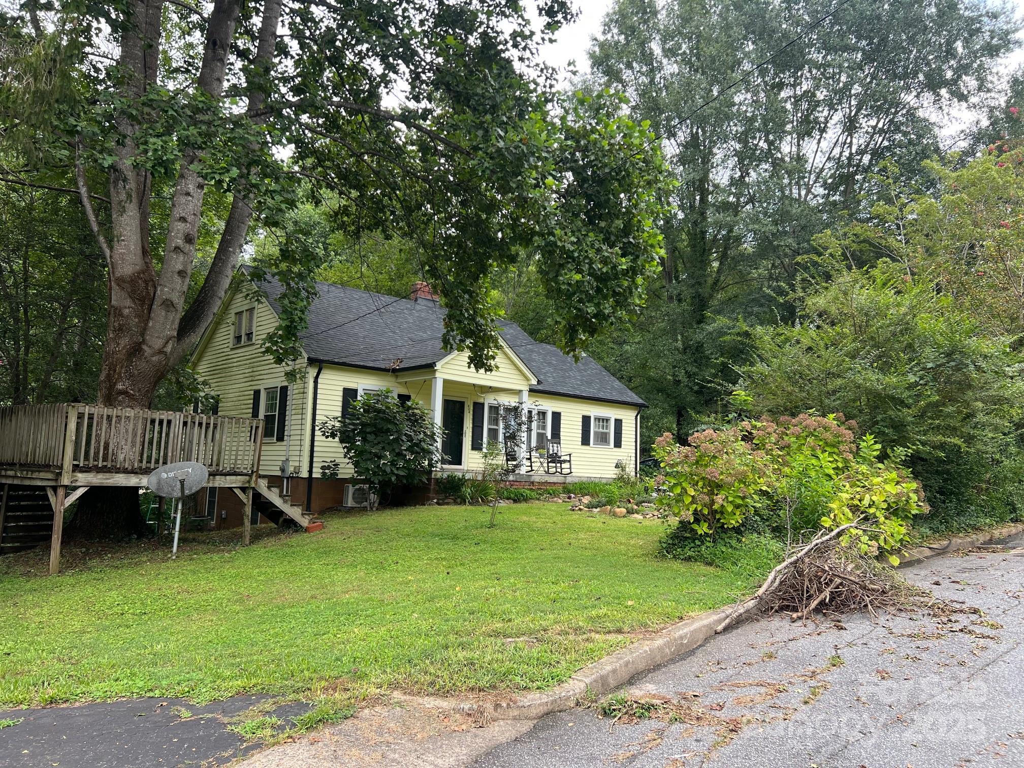 404 Patton Street Morganton, NC 28655 - Photo 6 of 40 a front view of a house with a garden and trees