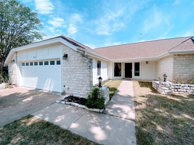 a front view of a house with yard
