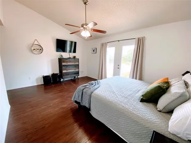 a bedroom with a bed and a flat screen tv