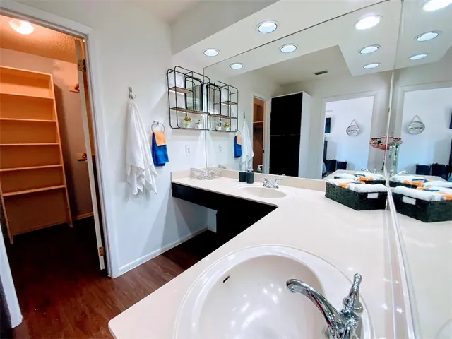 a living room with lots of furniture and a wooden floor