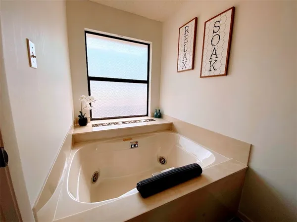 a bathroom with a tub and a window