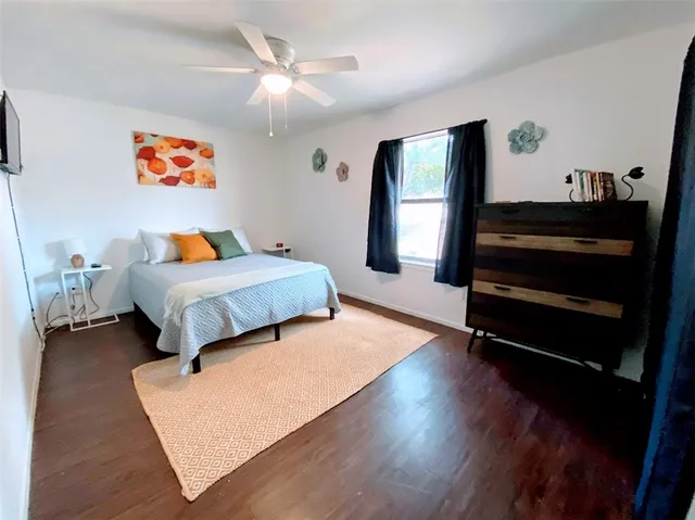a bedroom with furniture and wooden floor