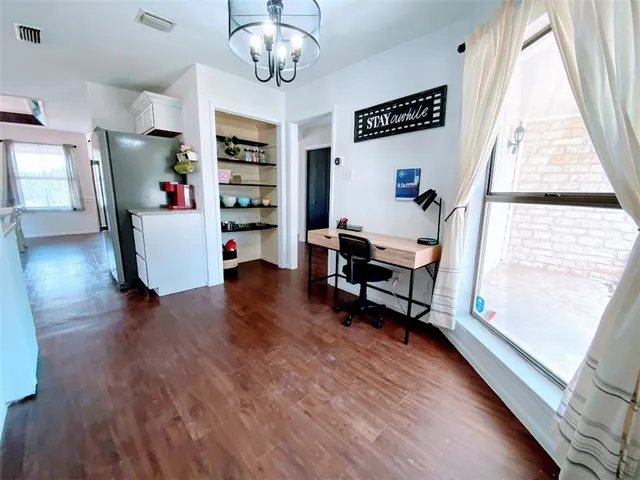 a view of a livingroom with furniture wooden floor and windows