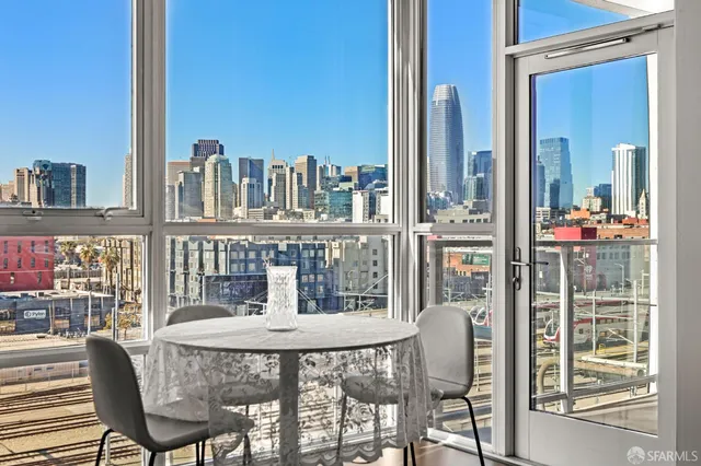 a dining room with furniture and a floor to ceiling window