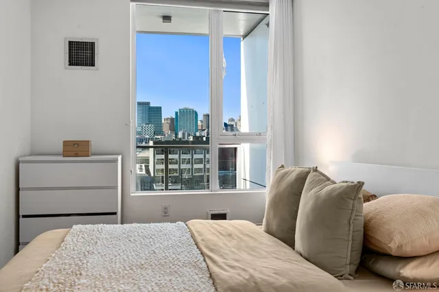 a bedroom with a bed and a window