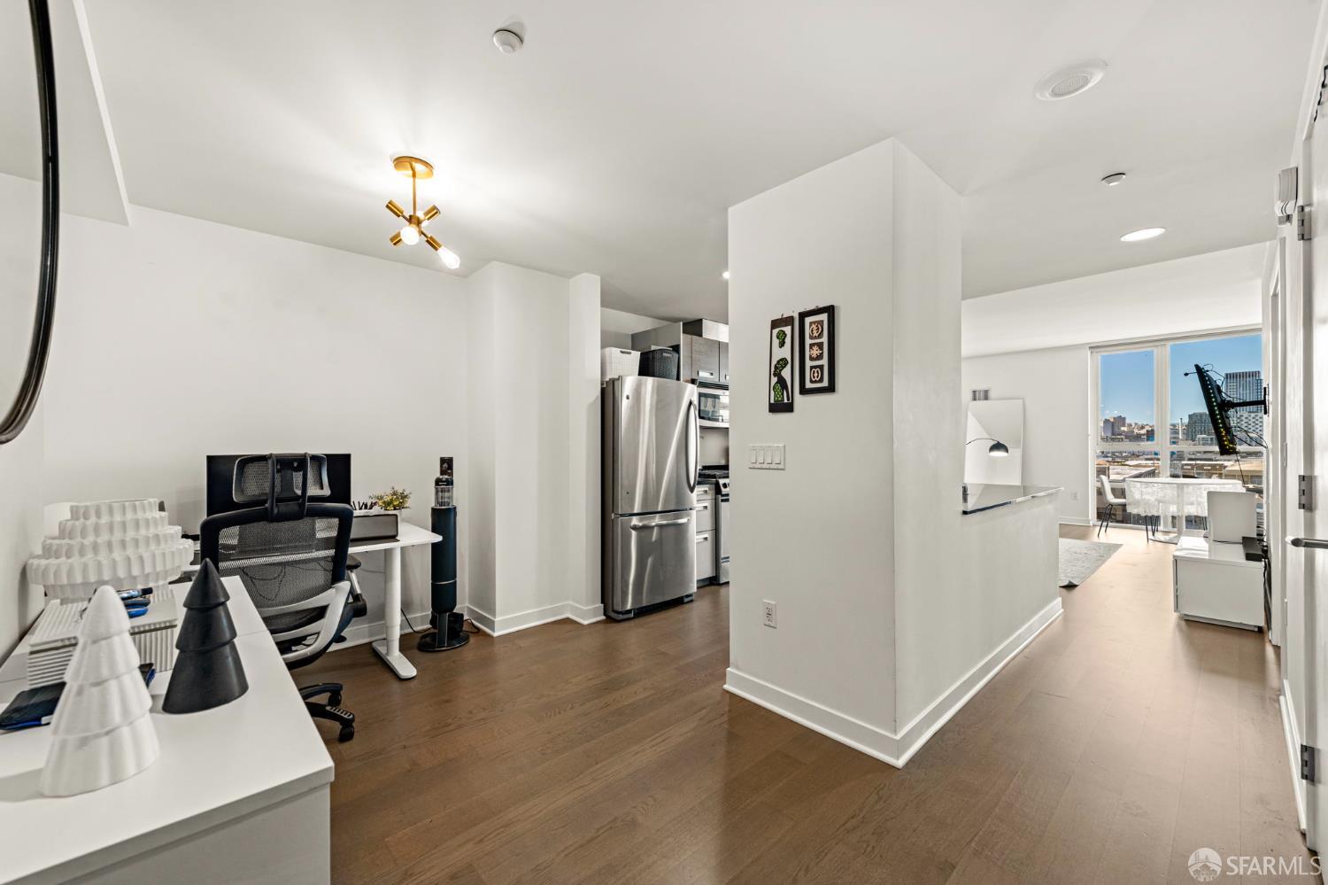 300 Berry Street, Unit 721 San Francisco, CA 94158 - Photo 5 of 27 a view of a kitchen with refrigerator and workspace