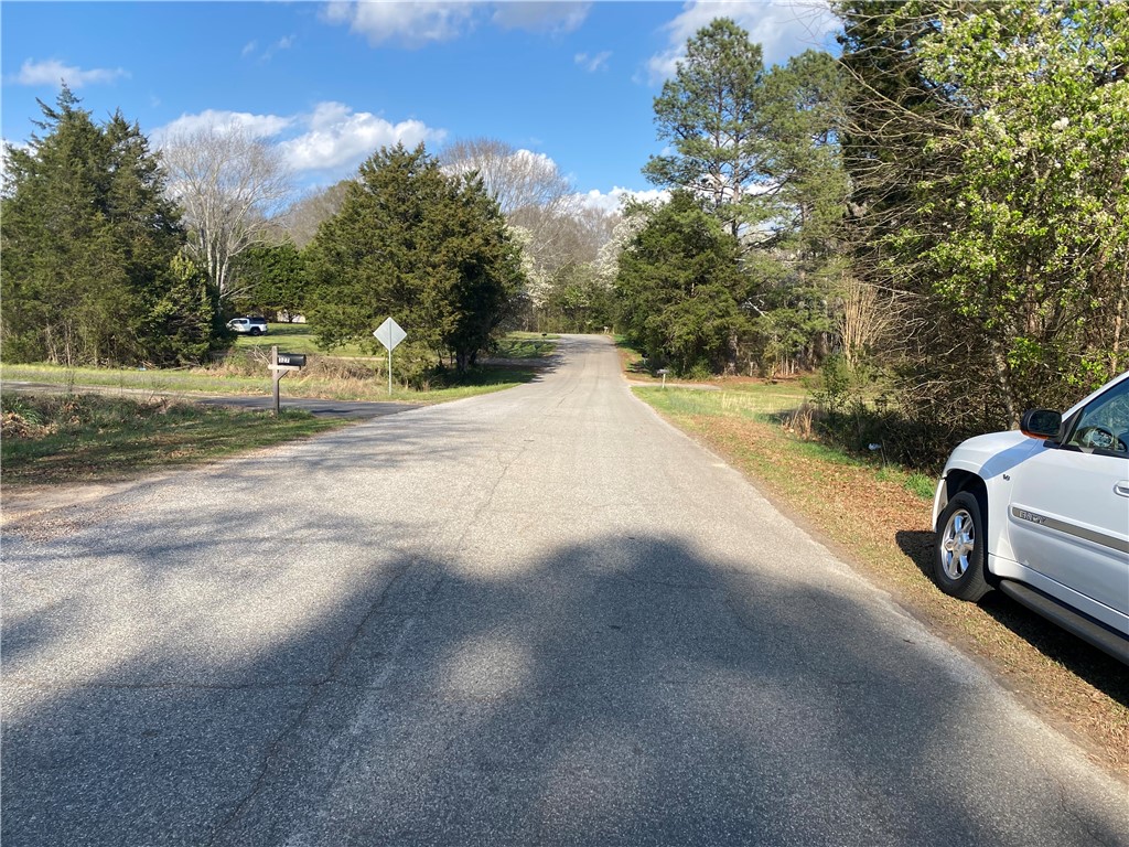 71 A Hicks Drive Starr, SC 29684 - Photo 3 of 11 This tranquil country road is enveloped by lush greenery, offering a peaceful retreat.