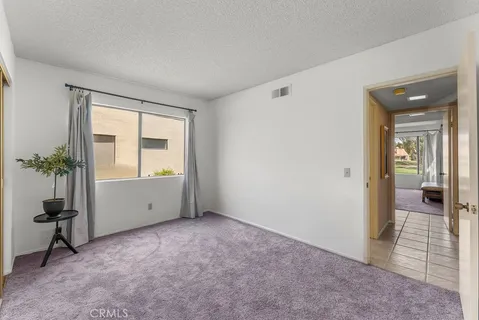 a bedroom with a large bed and a painting on the wall
